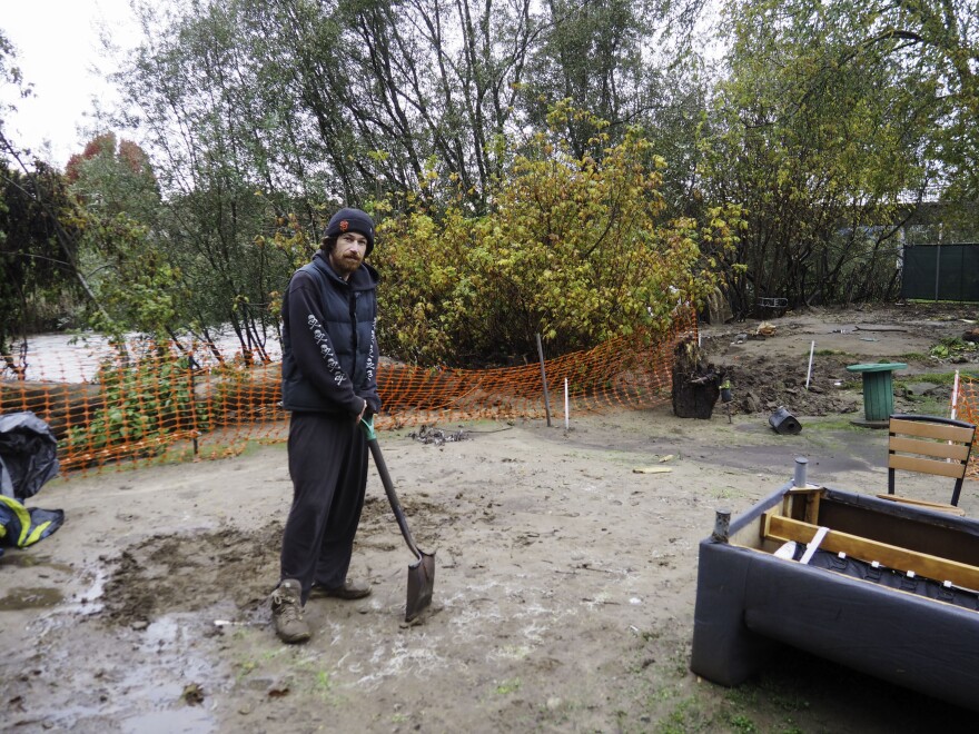 Tim Bone has lived in the Benchlands since October. He was moving his tent and belongings back to their spot Tuesday morning after he fled the rising water the previous night.