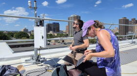Researchers at SUNY ESF examine an air quality monitor in Syracuse.