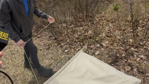 Alex Soldo using a tick drag to capture and count ticks on the Albany Pine Bush Preserve