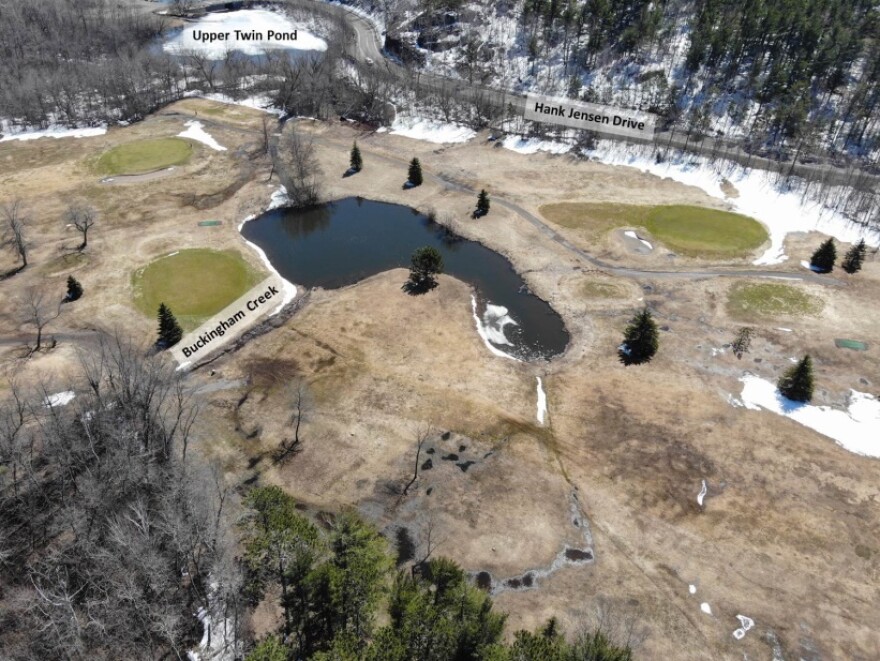 Overhead photo of a golf course with two bodies of water labeled