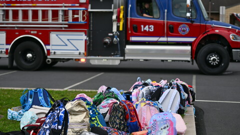 Childrens' bookbags sit outside of the Wyoming Area Catholic School after children were bused to Wyoming Area Secondary School following a fire at the Catholic school on Tuesday, Sept. 1, 2026.