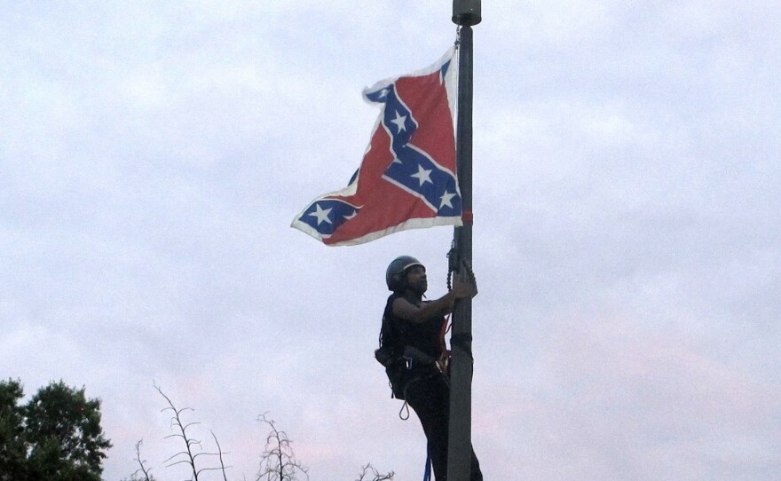 An image of activist Bree Newsome scaling the flagpole at the South Carolina State House