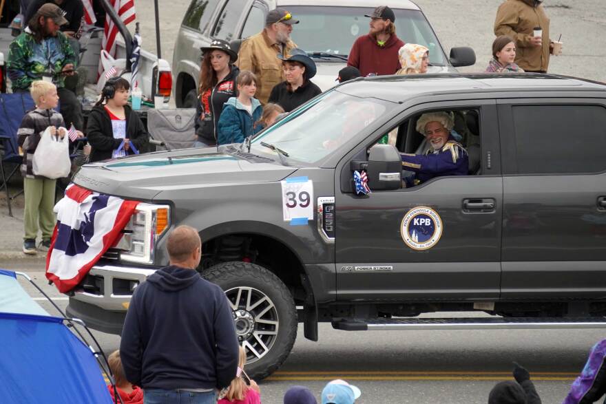 Kenai Peninsula Borough Mayor Peter Micciche wears a powdered wig in the Independence Day parade while proceeding down North Willow Street in Kenai, Alaska, on July 4, 2026. The borough government earned best political or goverment entry in the parade.