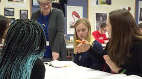A teacher listens to student questions during an in class project in Kokomo.