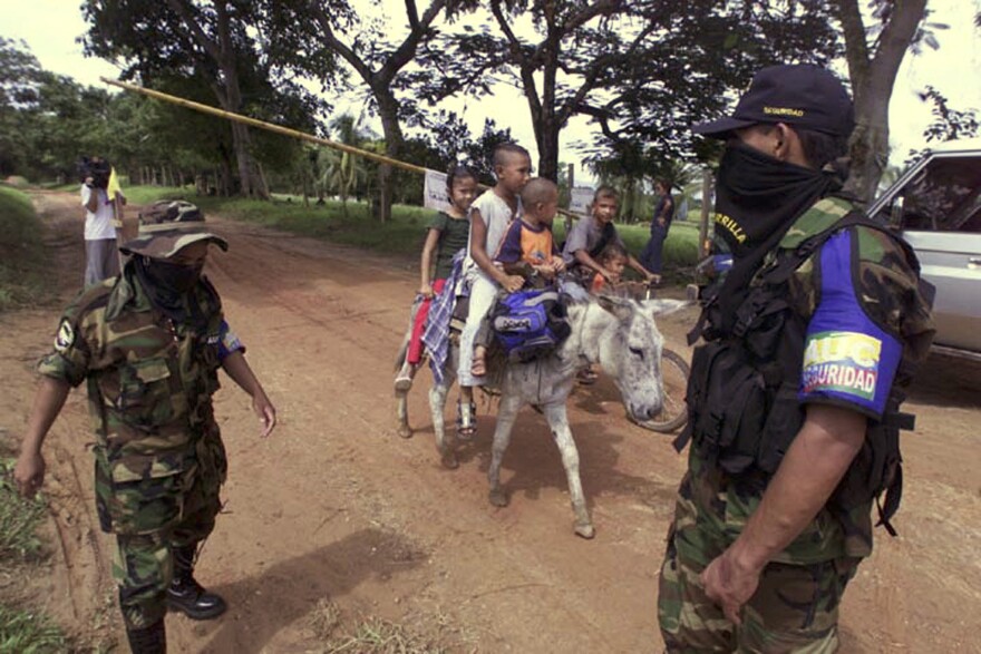 Right-wing Colombian paramilitary enforcers stop campesinos at a roadblock in Santa Fe de Ralito, Colombia, in 2004.