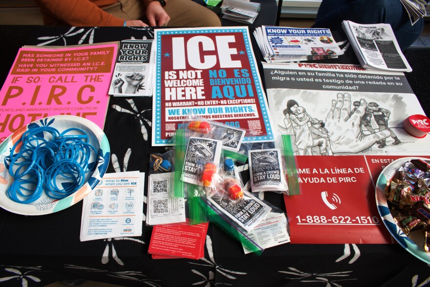 A table for the Portland Immigrant Rights Coalition includes resources, stickers and whistles for visitors on March 16, 2026.