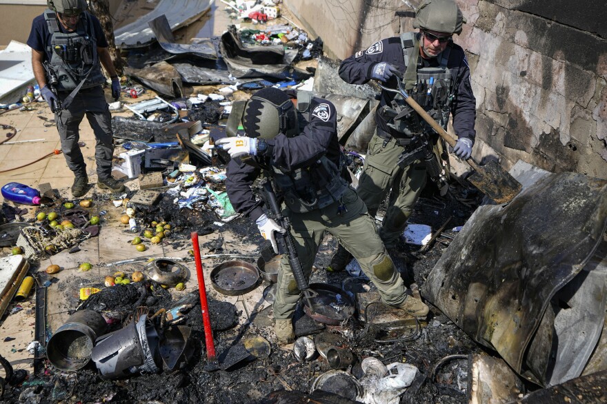 Sun., Oct. 15: Israeli police extinguish a fire at a site struck by a rocket from the Gaza Strip, in the town of Sderot, southern Israel.