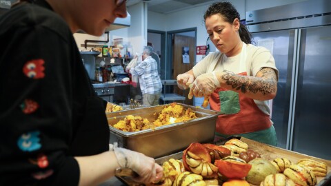 Rosaline Burr (center), program coordinator at Dimitri House, and volunteer Krystina Herdzik prepare for a Thanksgiving lunch to be served the next day for guests at Dimitri House on Tuesday, November 25, 2025. Dimitri House provides outreach to people experiencing poverty and homelessness in Rochester through its food cupboard and hot lunch program, both of which have seen an increase in demand over the past year.