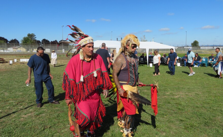 OSCI inmates Paul Canul (left, with headdress) and Stephen Mathew Lister-Galiza (right, with feather fan and staff) participate in an intertribal dance with special guests.