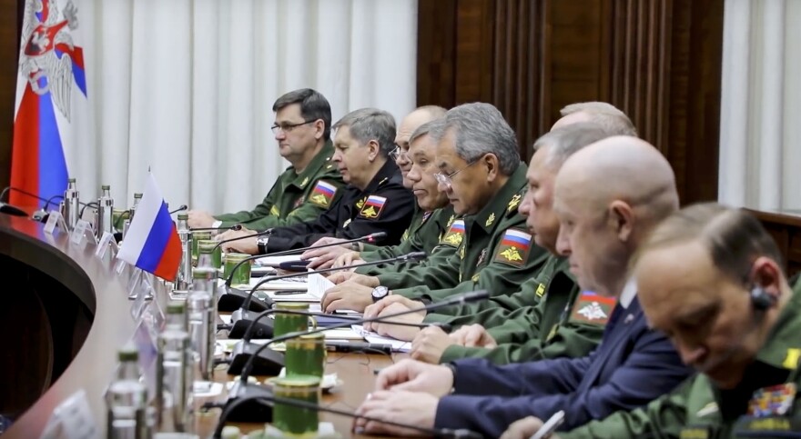 Russian businessman Yevgeny Prigozhin, in a dark suit, second from right, attends a meeting involving top Russian defense officials and members of Libya's National Army in Moscow on Nov. 7, 2018. The photo is taken from a video released by the Libyan National Army.