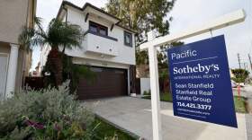 A home for sale sign in front of a house in Huntington Beach.   (Allen J. Schaben / Los Angeles Times via Getty Images)