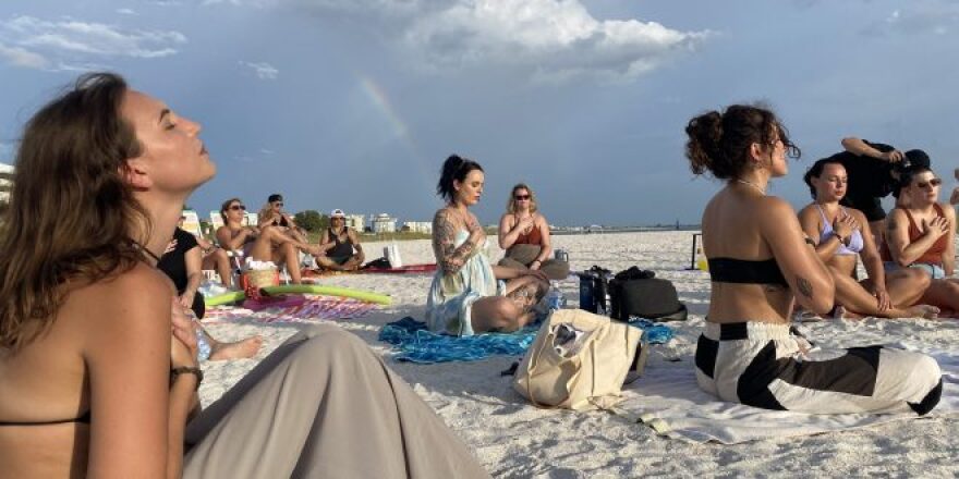 As the ritual begins, members of the coven are asked to place their hands above their hearts and release whatever they need to. Sydney Sickles (left) joins the coven for this after leading an astrological talk minutes before.