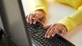 business, technology, school, people and education concept - close up of african american businesswoman or student girl hands with computer sitting at table