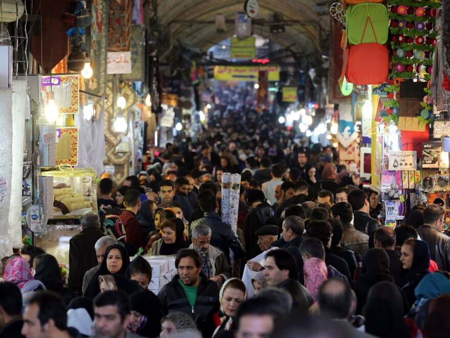 Iranians shop in Tehran's ancient Grand Bazaar on Jan. 16, 2016, the day many sanctions were lifted as part of a nuclear deal. President Rouhani called the deal a "golden page" in Iran's history.