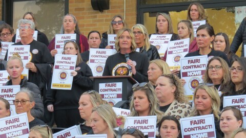 Math teacher Amy Brossart speaks alongside dozens of Ross teachers.