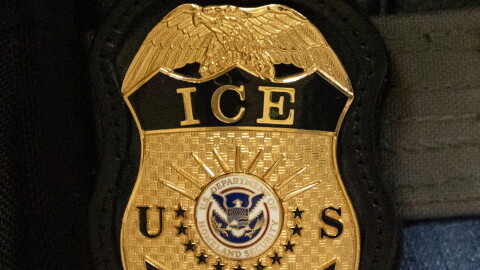 FILE - A federal agent wears an Immigration and Customs Enforcement badge in New York, June 10, 2025.
