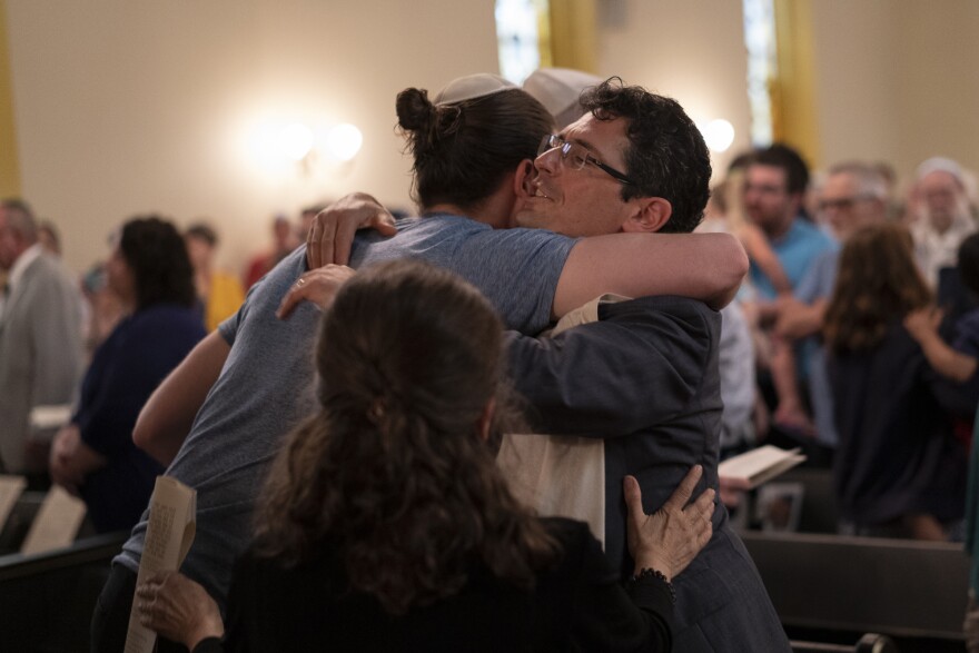 Rabbi Justin Kerber hugs congregant Sam Karoll during the temple's deconsecration ceremony on May 18, 2019.