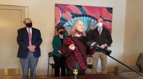 Louison House Executive Director Kathy Keeser, with State Representative John Barrett, North Adams Mayor Jennifer Macksey, and State Senator Adam Hinds behind her.