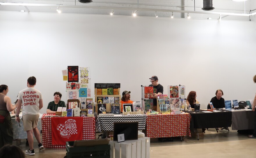 Multiple vendors selling books and magazines with white background.