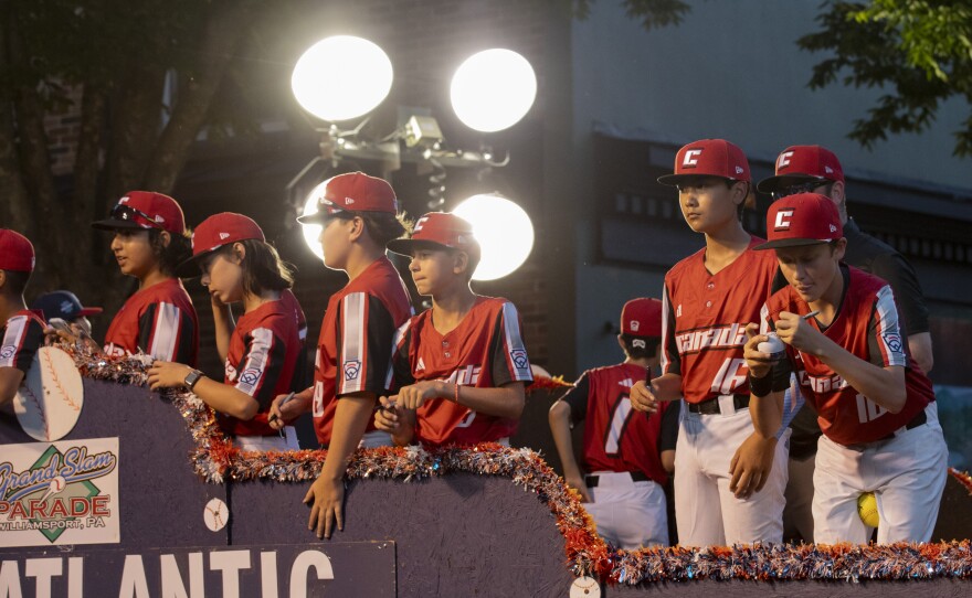 The Canadian team rides down West Fourth Street during the Little League World Series parade.