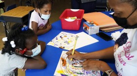 Laiah Collins, 4, top left, and Charisma Edwards, 5, work with Davetra Richardson (STLS), right, in a classroom at Chalmers Elementary school in Chicago. (Nam Y. Huh/AP)