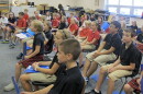 Students sing and play music games during choir class at St. Charles Catholic School in Bloomington. (Elle Moxley/StateImpact Indiana)