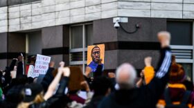 Demonstrators raise their fists as they protest outside the Hennepin County Government Center during jury selection at the trial of former Minneapolis Police officer Derek Chauvin in Minneapolis, Minnesota.