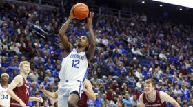 Kentucky's Antonio Reeves (12) shoots as Bellarmine's Sam DeVault (14) and Garrett Tipton (10) watch during the first half of an NCAA college basketball game in Lexington, Ky., Tuesday, Nov. 29, 2022. (AP Photo/James Crisp)
