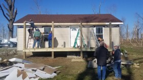 Habitat for Humanity volunteers work on the home of Barbara Atwill to repair it after the December tornado outbreak.