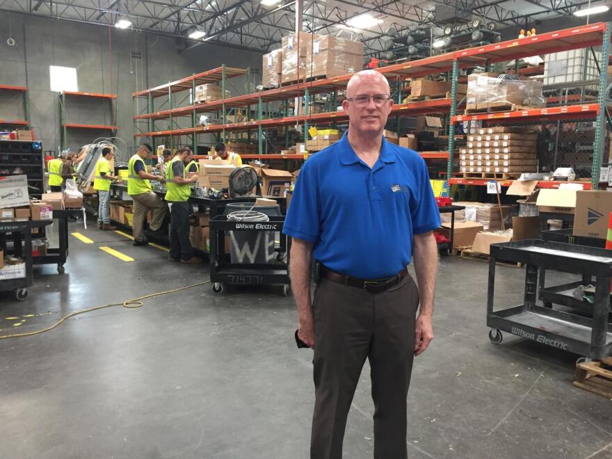 Mark Holohan, solar division manager at Wilson Electric, stands in his company's warehouse outside Phoenix, AZ. Across the country, solar installers say a proposed tariff on foreign-made solar panels could sink their business model.