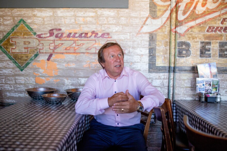 Wes Pikula sits at a booth in Buddy's pizza looking to the side 