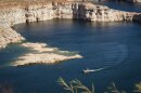 A boat passes rock formations in Lake Powell near the Utah-Arizona border, April 24, 2024. Forecasts now say the reservoir could reach new record lows by the end of 2026, heightening the stakes for states fighting over the Colorado River’s water.