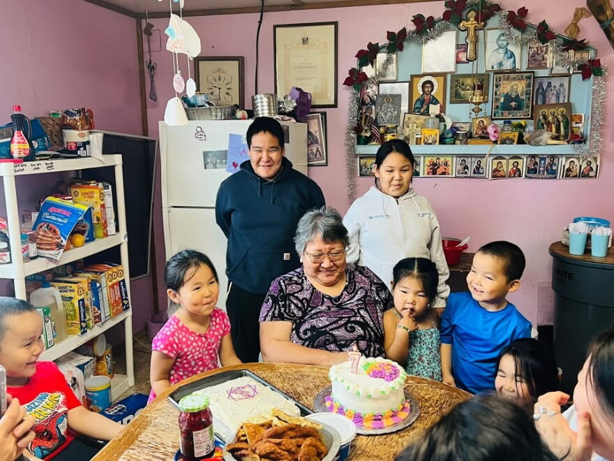 Marie White and her grandchildren celebrate her birthday in Kwigillingok, just days before ex-typhoon Halong severely damaged the home. Oct. 1, 2025.