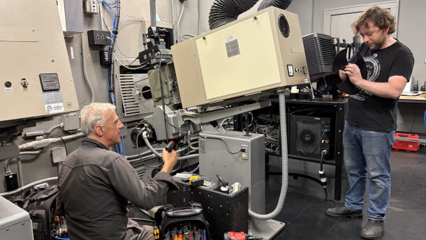 Milwaukee Film technical director Kevin Rice (right) and renowned Chicago-based projectionist James Bond work on installing brand new shutters for the projector that were manufactured specifically for the Oriental Theater's projectors.