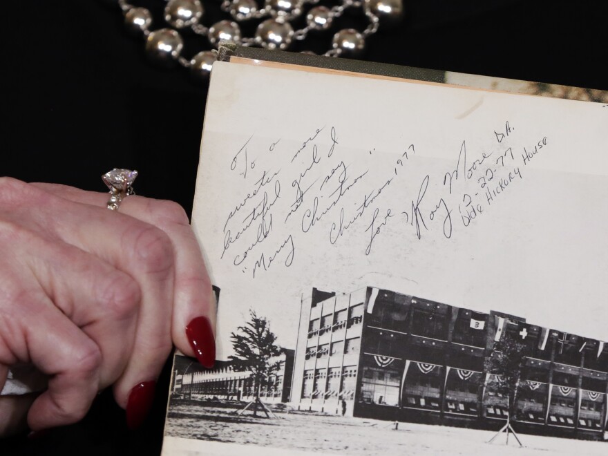 Nelson, one of several accusers of Alabama Republican Roy Moore, shows her high school yearbook she alleges was signed by Moore, at a news conference last month.