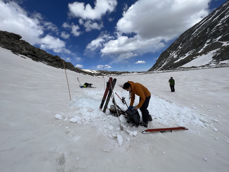  Katherine Hale bends down to grab something out of her backpack while standing near the Continental Divide in the Front Range, Colo.