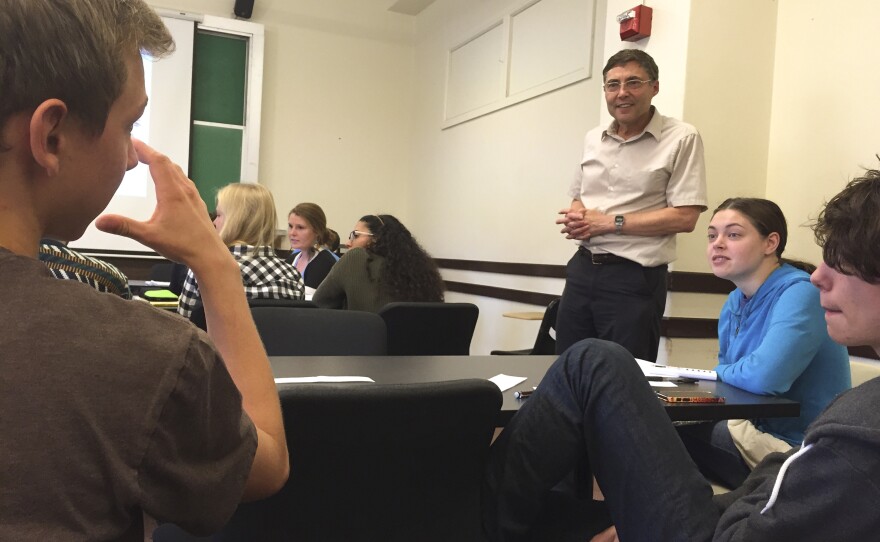 Dr. Carl Wieman listens in on a small group discussion during his introductory quantum mechanics course at Stanford University.