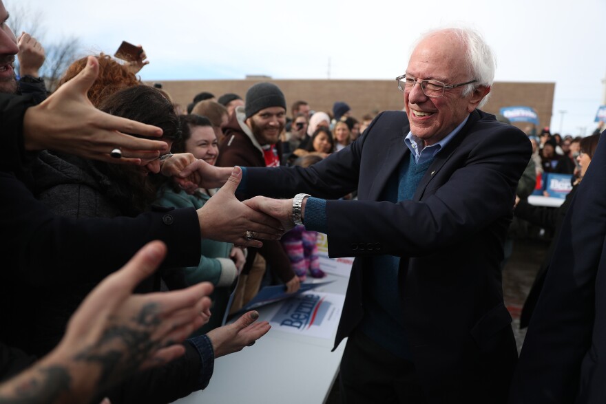 Vermont Sen. Bernie Sanders greets people at a campaign field office in Cedar Rapids, Iowa. Sanders is the slight favorite to win the caucuses, and he hopes it vaults him to the Democratic nomination.