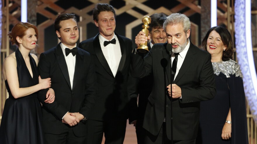 Sam Mendes accepts the award for best drama movie for <em>1917</em> at the Golden Globes on Sunday night.