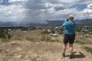 Woman takes a photo of smoke in the distance.