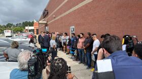 Gov. Josh Stein talks with DMV customers outside a Raleigh office on May 30, 2025.