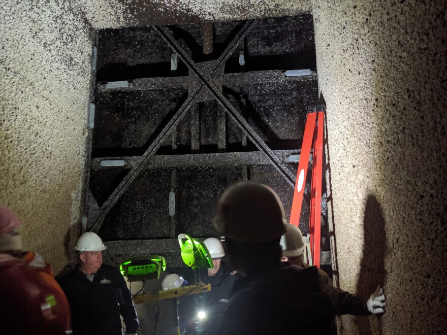 A group touring the construction at the Ballard Locks looks at one of the six stoney gate valves that will be replaced between now at 2021. The valves are original to the locks, putting them at more than 100 years old.