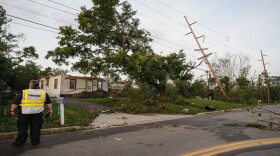 Storm damage litters a residential neighborhood Tuesday, May 28, in Vandalia, Ohio. A rapid-fire line of apparent tornadoes tore across Indiana and Ohio overnight, packed so closely together that one crossed the path carved by another. 