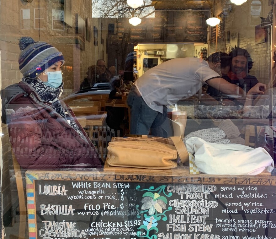 Fati sits in the window of a cafe in downtown Northampton, Massachusetts. 