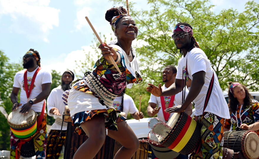 People performing live music and dancing during a Juneteenth celebration in West Hartford.