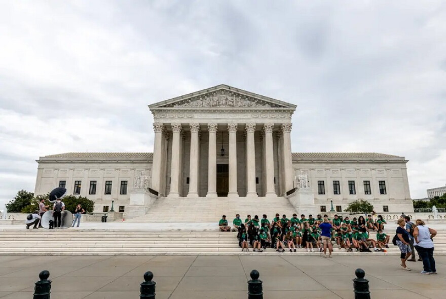 Children listen to a tour guide on the steps of the U.S. Supreme Court in Washington, D.C. Credit: