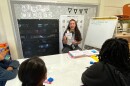 Zoe Klein, a senior at UNC Charlotte's Cato College of Education, works with fourth-graders at Niner University Elementary, where aspiring teachers develop hands-on skills.