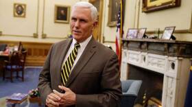 Then Gov. Mike Pence speaks after a meeting with Indianapolis Archbishop Joseph Tobin at the Statehouse Wednesday, Dec. 2, 2015, in Indianapolis, a day after the archdiocese said it has the means to resettle a Syrian refugee family bound for the state.