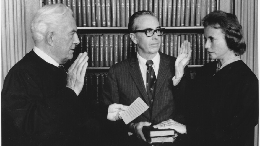 Sandra Day O'Connor is sworn in as an associate justice by Chief Justice Warren Burger on Sept. 25, 1981. Holding two family Bibles is husband John Jay O'Connor.