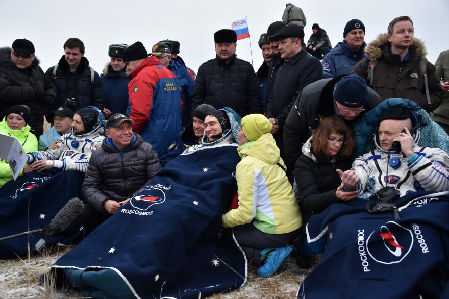 (From left) Russian cosmonauts Mikhail Kornienko and Sergei Volkov and U.S. astronaut Scott Kelly rest outside the space capsule after landing on Wednesday.